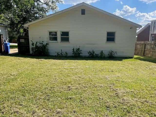 a view of a house with yard and furniture