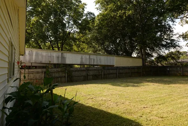 a front view of a house with yard and green space