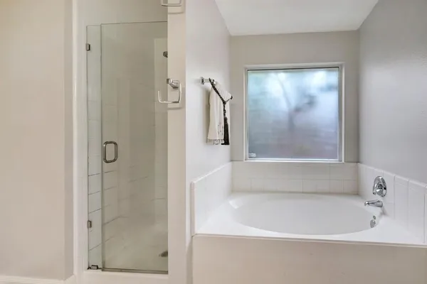 a bathroom with a bathtub and a shower