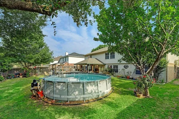 a view of a house with a backyard porch and sitting area