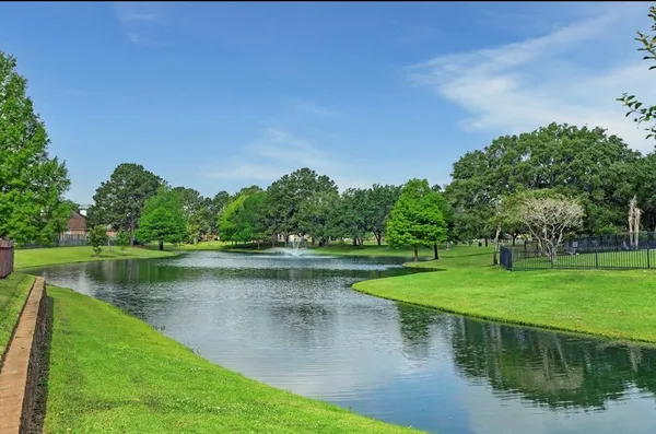 a view of a lake with a house in the background