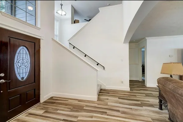 a view of an entryway with wooden floor