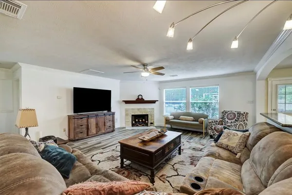 a living room with furniture a flat screen tv and a fireplace
