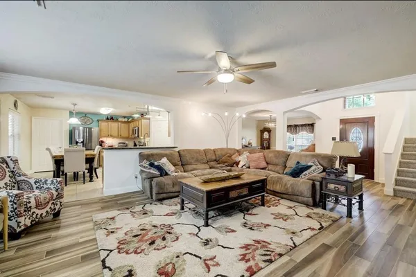 a living room with furniture a rug and a chandelier