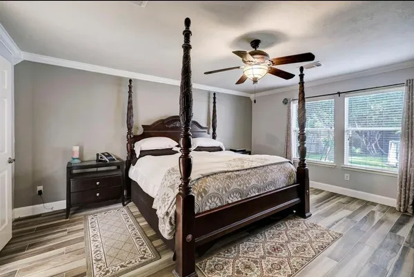 a bedroom with a bed and a chandelier
