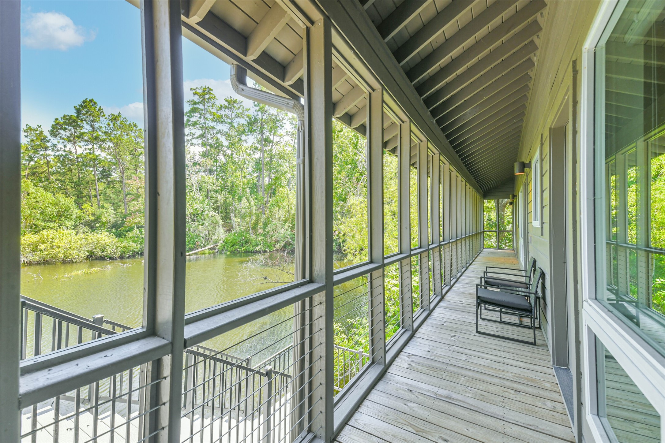 88 Raccoon Ramble Cleveland, TX 77327 - Photo 10 of 43 Experience serene waterfront views from this spacious, screened-in porch, perfect for relaxing and enjoying nature.