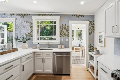 a kitchen with stainless steel appliances a sink stove and cabinets