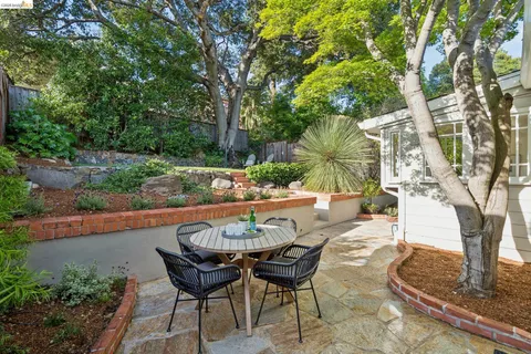 a view of a chairs and table in backyard