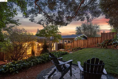 a view of a wooden dinning table and chairs in the garden