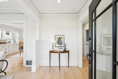 a view of a hallway with wooden floor and workspace