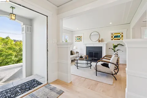 a living room with furniture a fireplace and a window