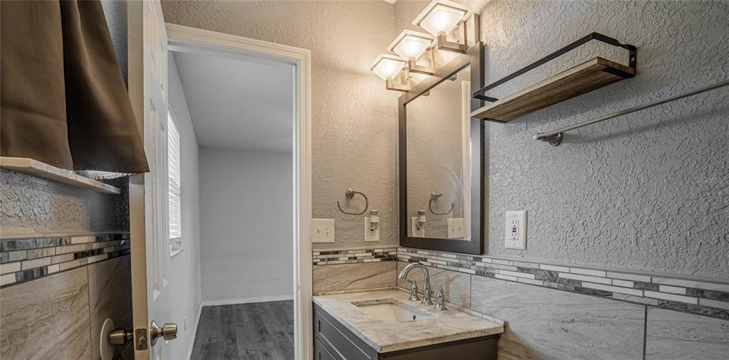 2814 William Lane Lakeland, FL 33812 - Photo 15 of 18 a bathroom with a sink and a mirror