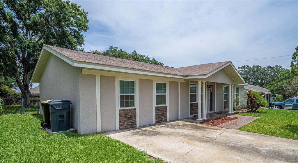 2814 William Lane Lakeland, FL 33812 - Photo 3 of 18 a view of a house with brick walls plants and large tree