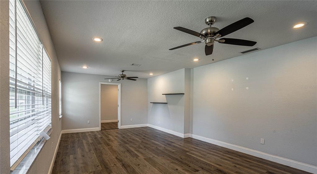 2814 William Lane Lakeland, FL 33812 - Photo 5 of 18 wooden floor in an empty room with a window