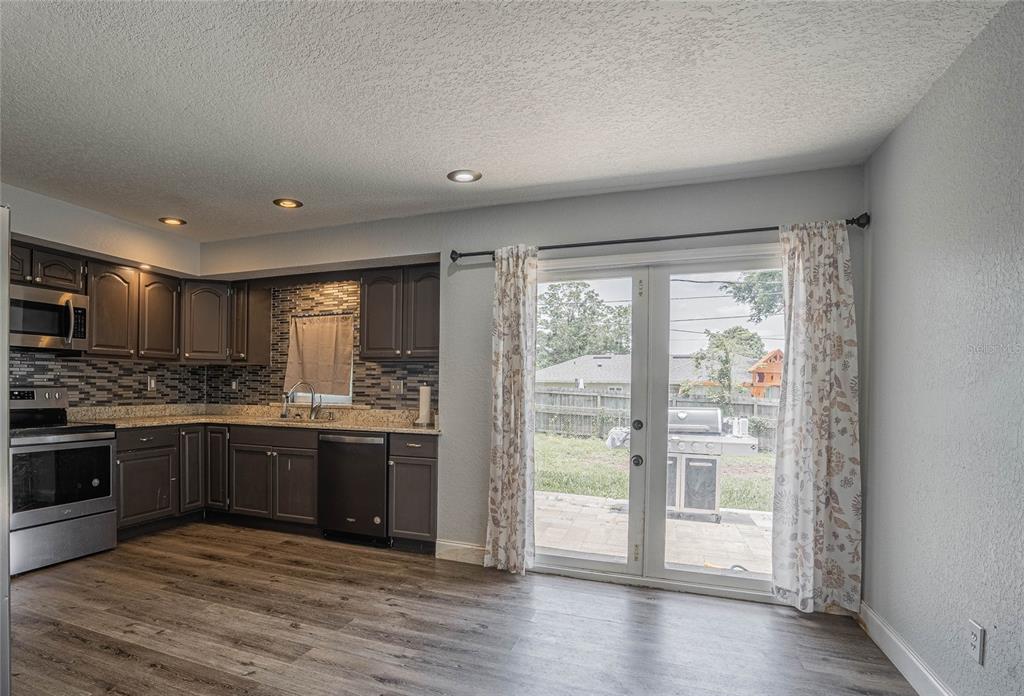 2814 William Lane Lakeland, FL 33812 - Photo 10 of 18 a large kitchen with stainless steel appliances granite countertop a stove and a sink