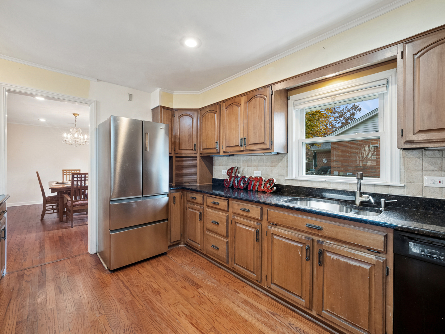 295 Ardmore Road Des Plaines, IL 60016 - Photo 9 of 30 a kitchen with stainless steel appliances granite countertop a refrigerator sink and cabinets