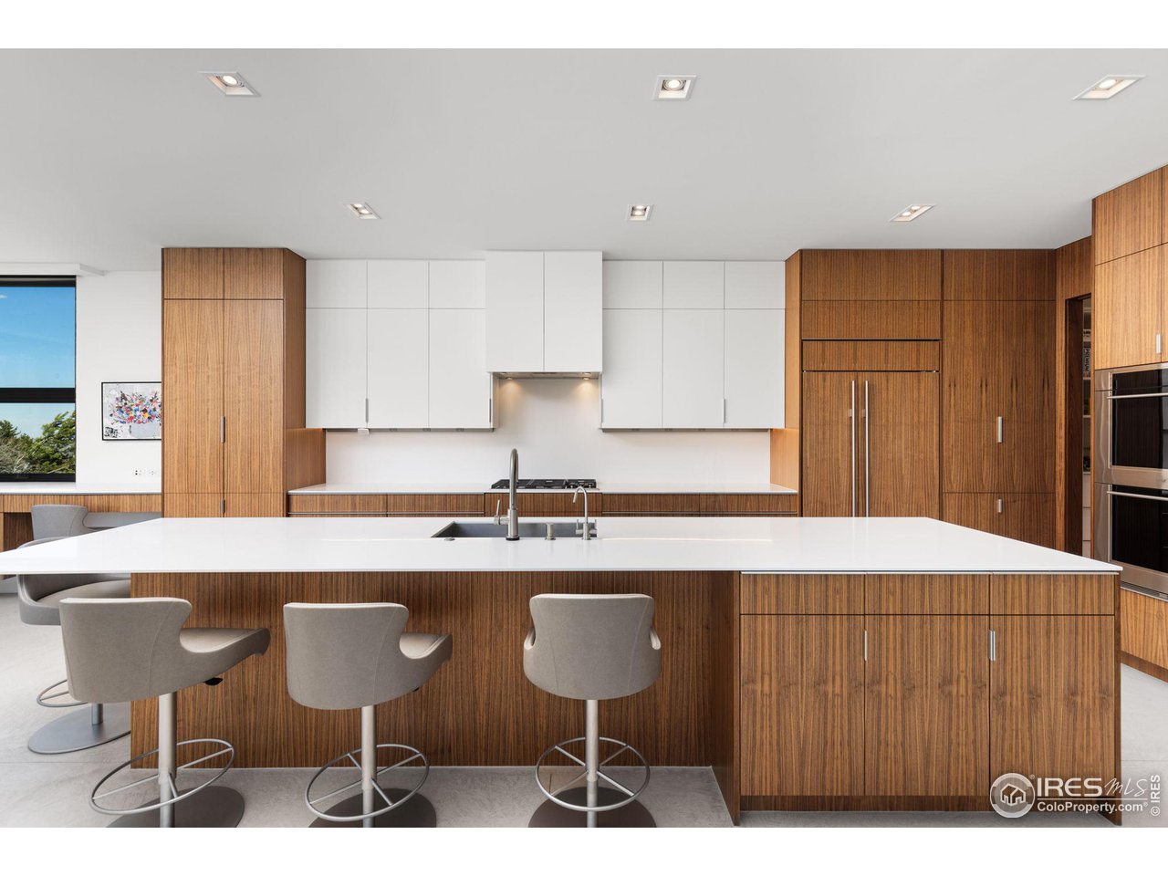 1775 Deer Valley Road Boulder, CO 80305 - Photo 11 of 40 a kitchen with a dining table chairs cabinets and stainless steel appliances