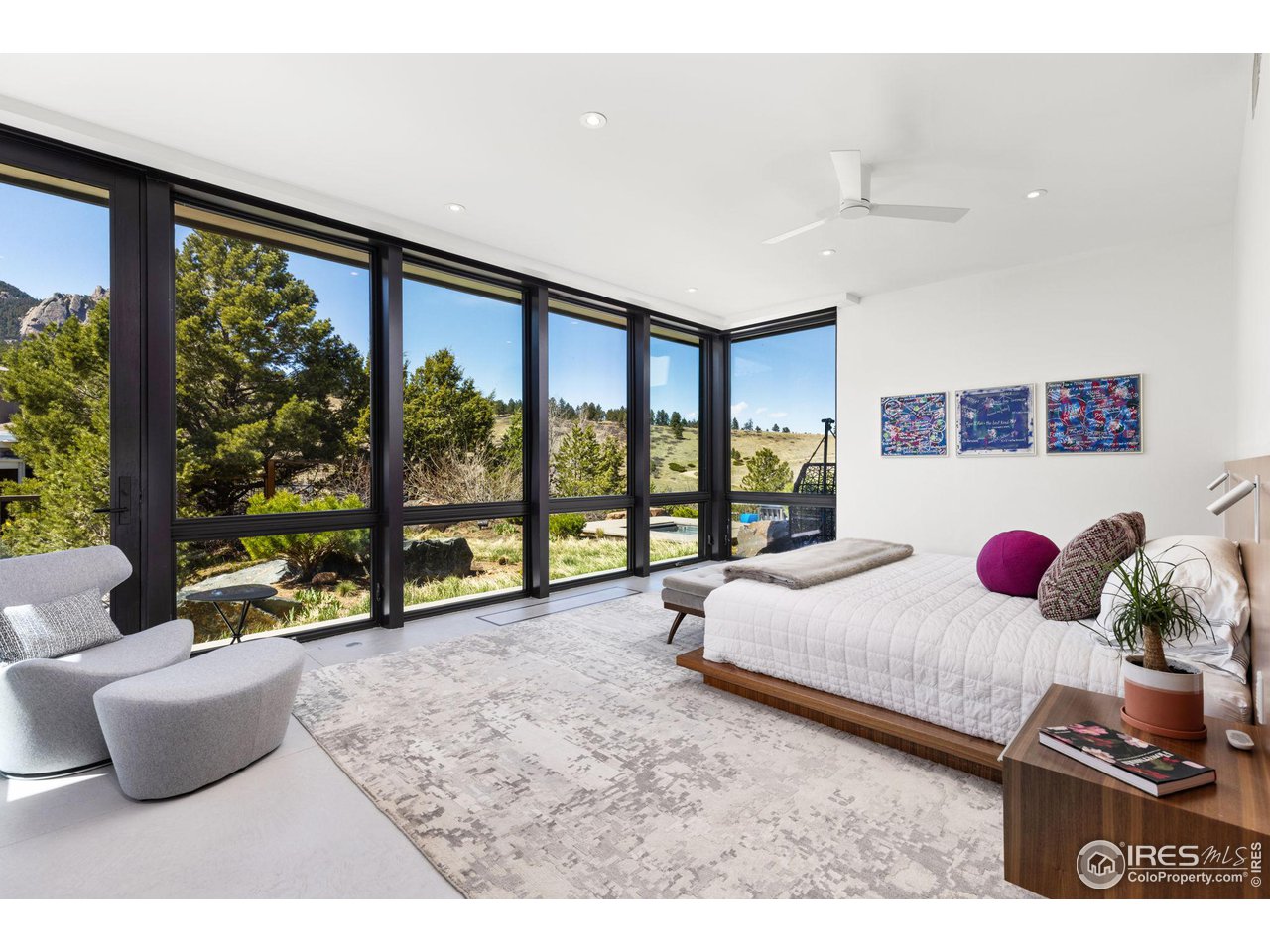 1775 Deer Valley Road Boulder, CO 80305 - Photo 23 of 40 a bedroom with furniture and large windows