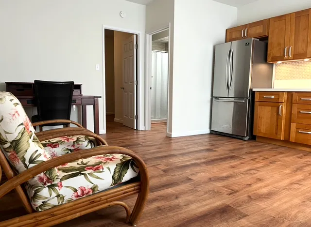 a bedroom with a bed and a refrigerator