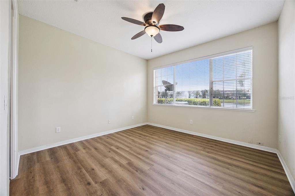 551 Terrace Spring Drive Orlando, FL 32828 - Photo 12 of 41 a view of a room with wooden floor and a ceiling fan