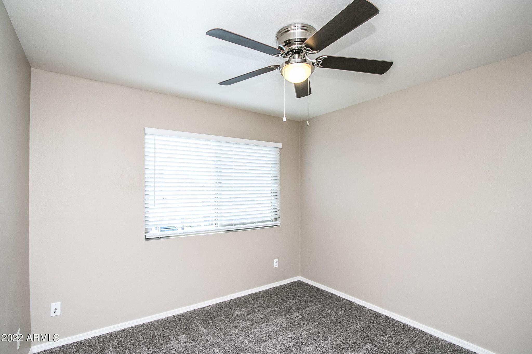 626 West 14th Street Tempe, AZ 85281 - Photo 17 of 27 an empty room with a window and a fan