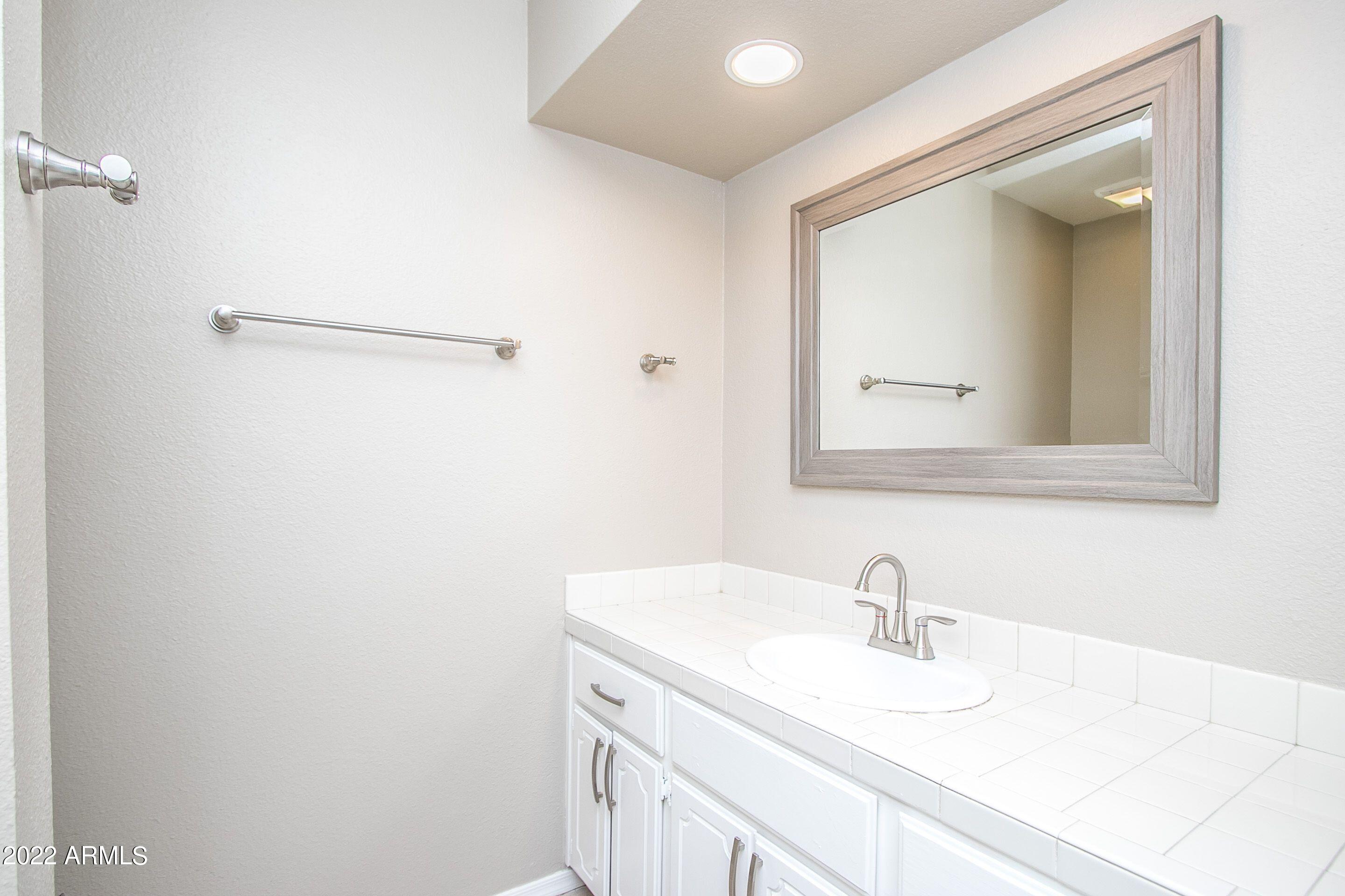 626 West 14th Street Tempe, AZ 85281 - Photo 22 of 27 a bathroom with a sink and a mirror