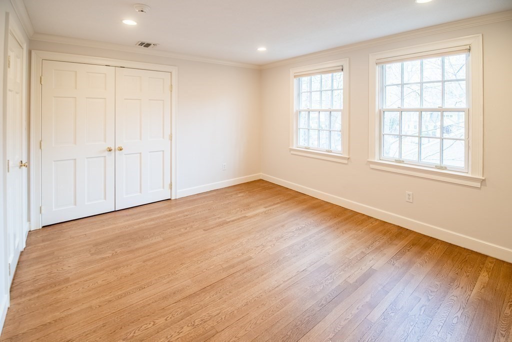49 Tanglewood Road Wellesley, MA 02481 - Photo 24 of 35 an empty room with wooden floor and windows