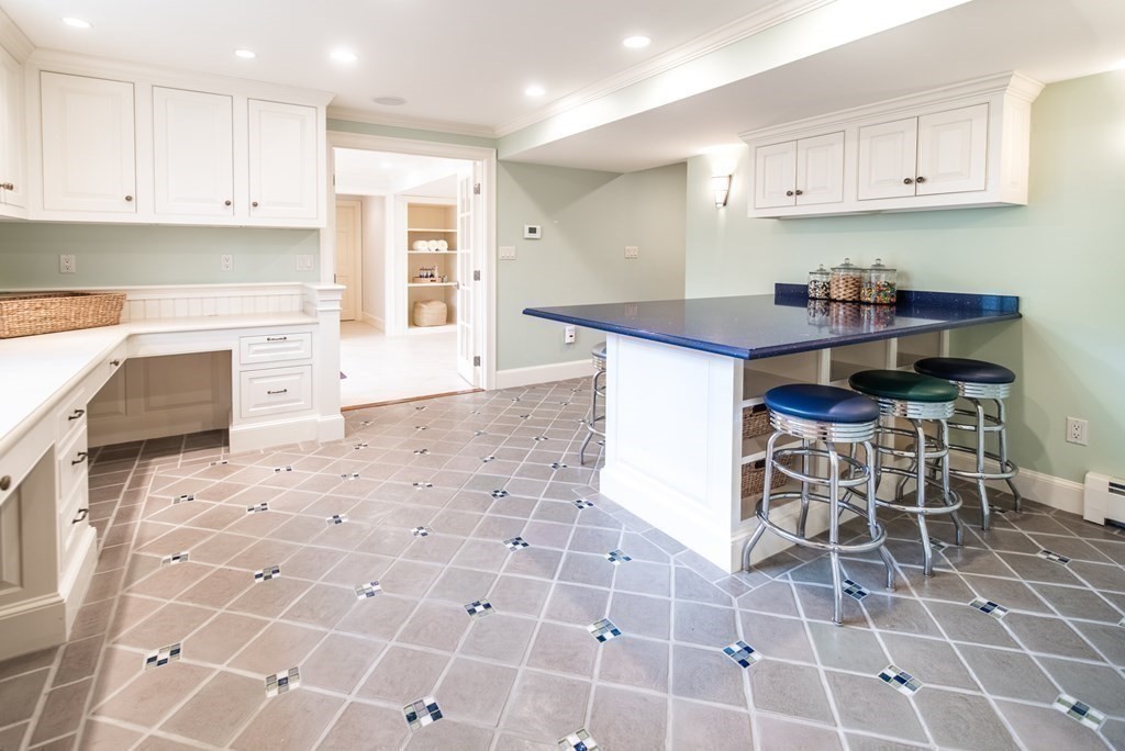 49 Tanglewood Road Wellesley, MA 02481 - Photo 29 of 35 a kitchen with stainless steel appliances a stove a sink cabinets and a dining table