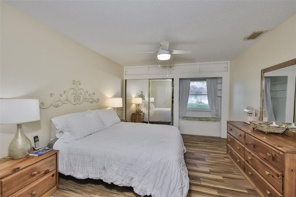 2034 Hawkhurst Circle, Unit 178 Sun City Center, FL 33573 - Photo 12 of 94 a bedroom with a bed and wooden floor