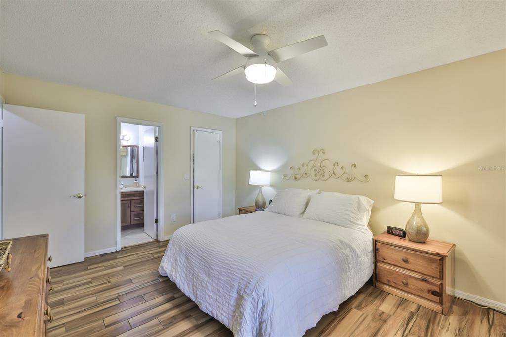 2034 Hawkhurst Circle, Unit 178 Sun City Center, FL 33573 - Photo 13 of 94 a bedroom with a bed and a lamp