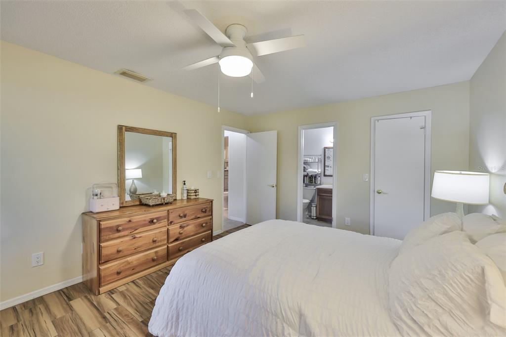 2034 Hawkhurst Circle, Unit 178 Sun City Center, FL 33573 - Photo 14 of 94 a bedroom with a bed and wooden floor