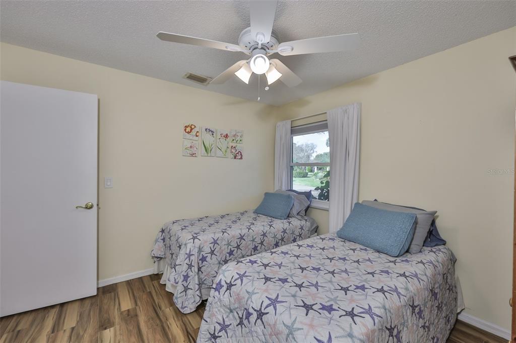 2034 Hawkhurst Circle, Unit 178 Sun City Center, FL 33573 - Photo 15 of 94 a bedroom with a large bed and a chandelier
