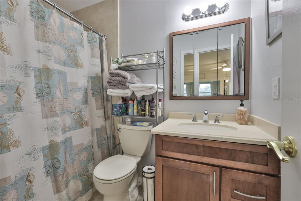 2034 Hawkhurst Circle, Unit 178 Sun City Center, FL 33573 - Photo 17 of 94 a bathroom with a granite countertop toilet sink and mirror