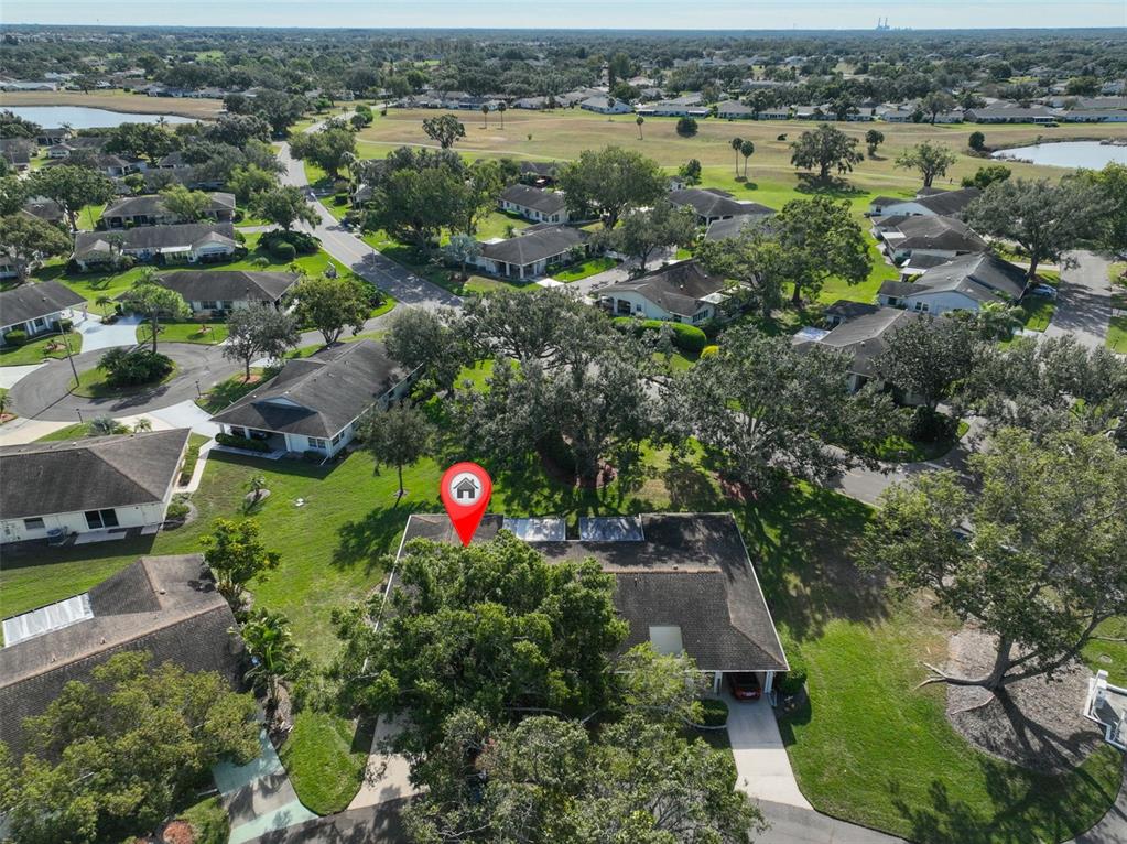 2034 Hawkhurst Circle, Unit 178 Sun City Center, FL 33573 - Photo 37 of 94 an aerial view of a houses with a yard and lake