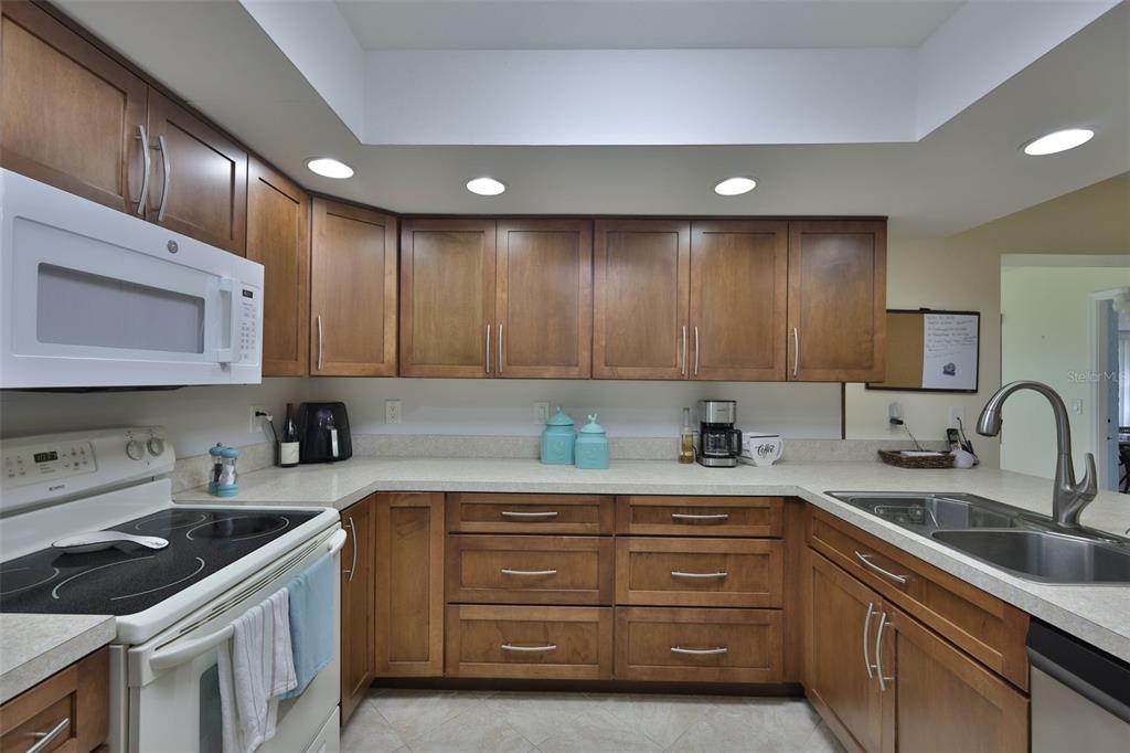 2034 Hawkhurst Circle, Unit 178 Sun City Center, FL 33573 - Photo 7 of 94 a kitchen with a sink stove and cabinets