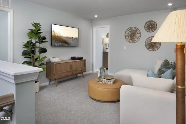 a living room with furniture and a flat screen tv