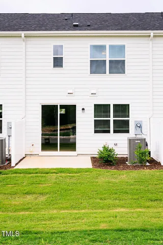 a front view of a house with a garden and yard