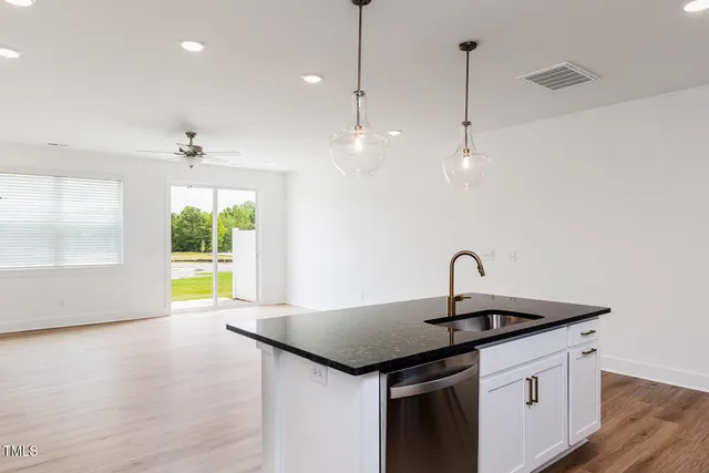 a kitchen with a sink a counter space and a window