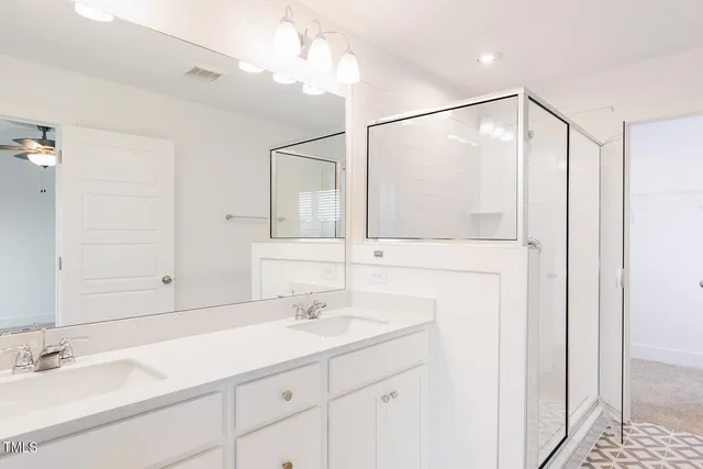 a bathroom with a sink vanity and a mirror