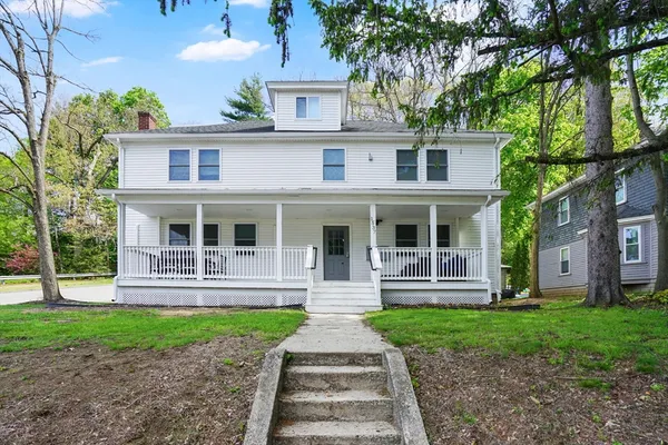a front view of a house with garden and porch