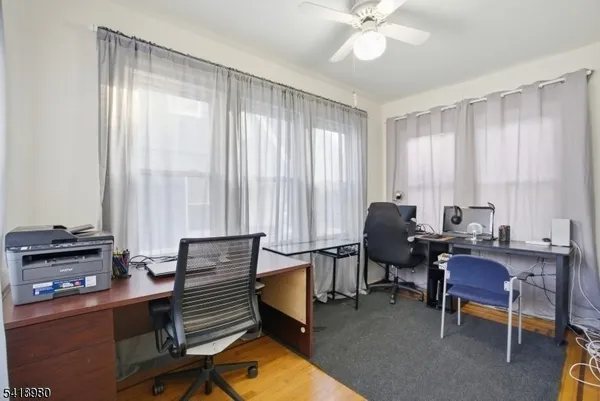 a view of a workspace with furniture and a window