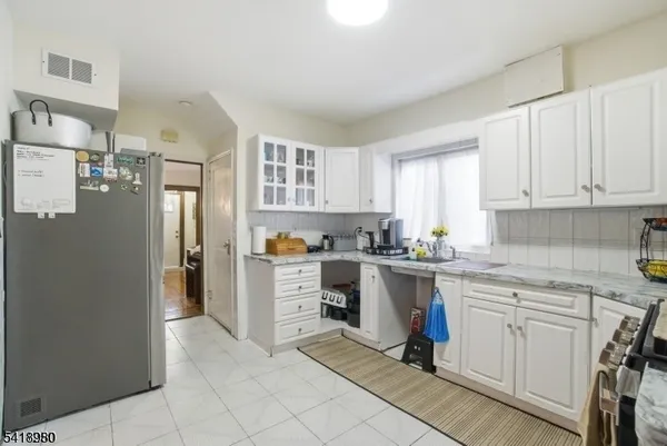 a kitchen with a refrigerator and cabinets