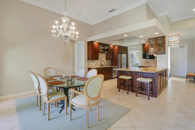 a bathroom with a granite countertop sink a toilet a large mirror and shower