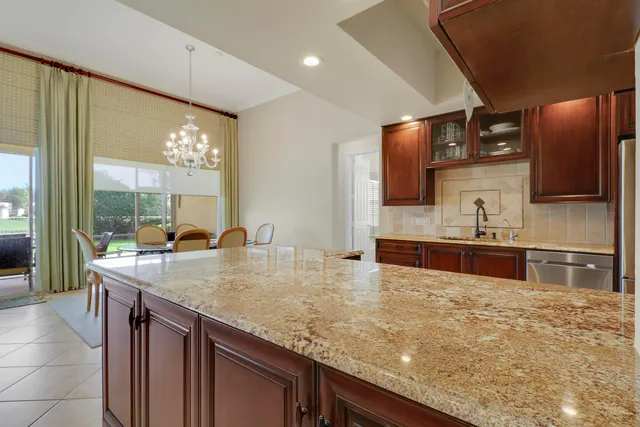 a bathroom with a granite countertop sink toilet and mirror