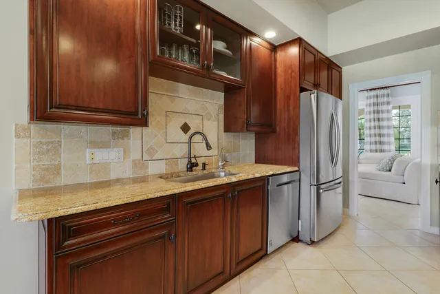 a dining room with furniture and a floor to ceiling window