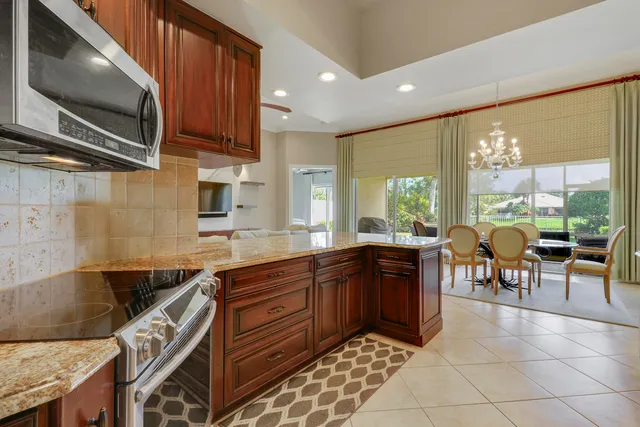 a view of a park with plants and palm trees