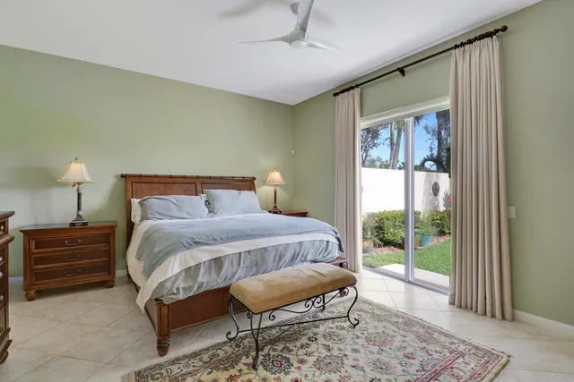 a front view of a house with a tree