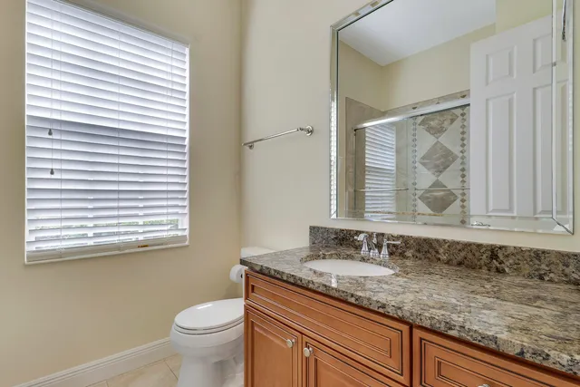 a view of a swimming pool with a table and chairs under an umbrella