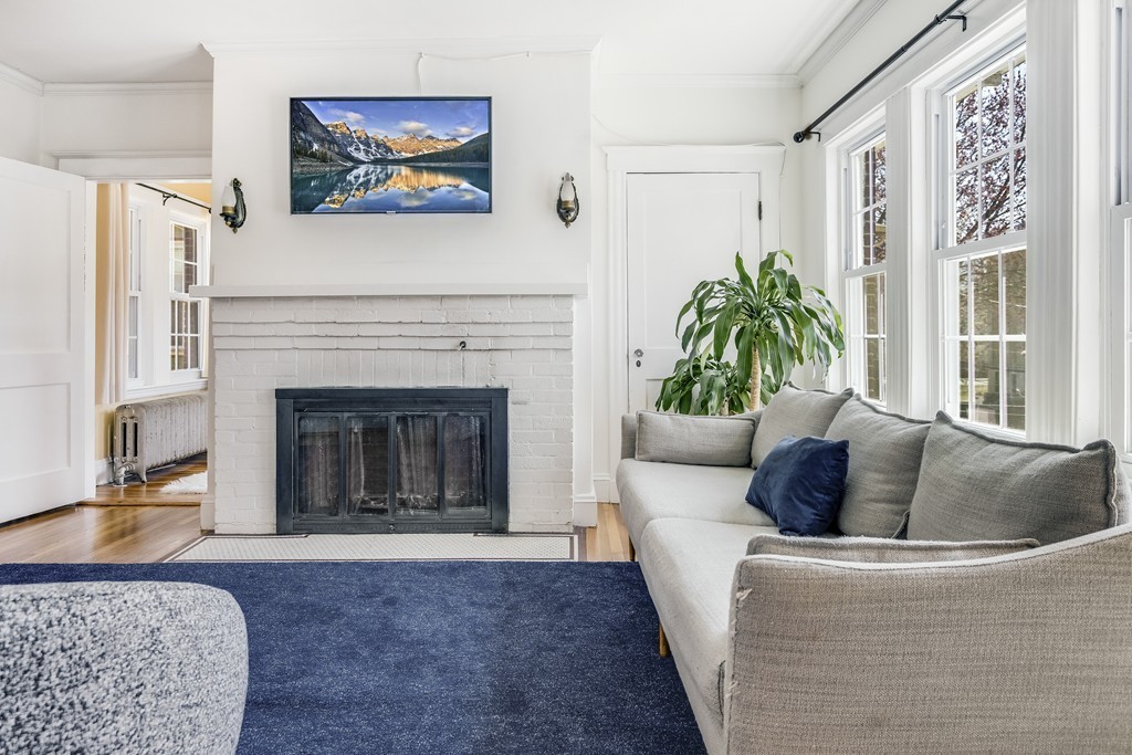 21 Pershing Road, Unit 2 Boston, MA 02130 - Photo 4 of 17 a living room with furniture and a fireplace