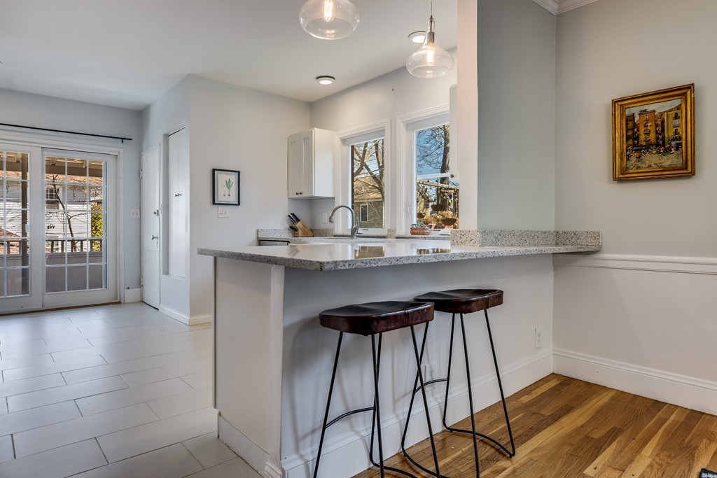 21 Pershing Road, Unit 2 Boston, MA 02130 - Photo 6 of 17 a kitchen with stainless steel appliances kitchen island a chandelier